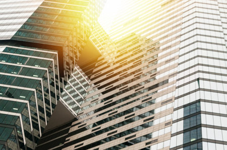 Modern glass building business center. Skyscraper in the city. The sun's rays are reflected in the glass surface of the building. Bottom viewの写真素材