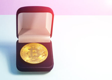 Coin bitcoin in a gift box for a ring or jewelry. The concept of crypto currency. The best gift for the holiday. A gift in Christmas. On blue background.の写真素材