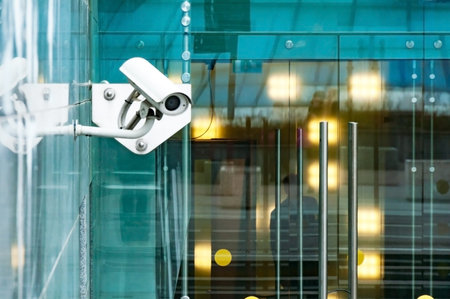 Security surveillance system at the entrance to a modern office building. Two cameras of video...