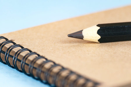 Notepad for drawing from recycled paper. On a spiral mount. A large pencil for sketching. Selective focus.の写真素材