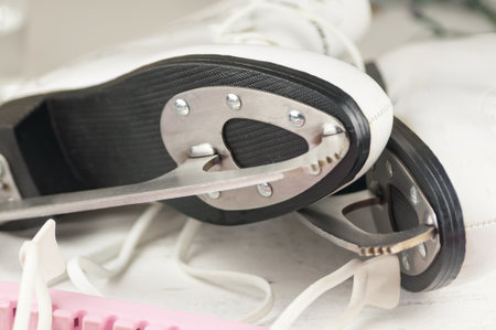 Vintage white female skates for figure skating, on a light wooden backgroundの写真素材