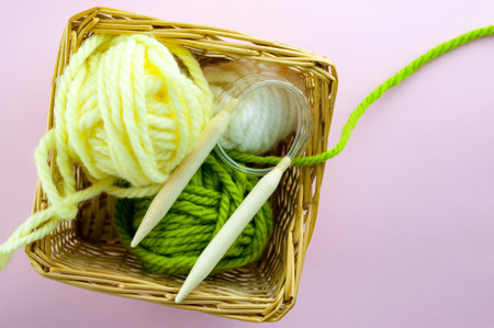 Vintage Knitting needles and yarn on a pink background, a cap tied with white natural wool. With the blur. DYVの写真素材