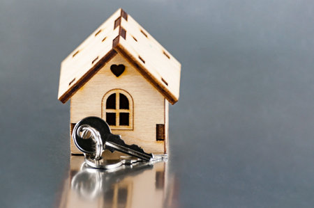 The little house next to the keys. Symbol of hiring a house for rent, selling a home, buying a home, a mortgage.