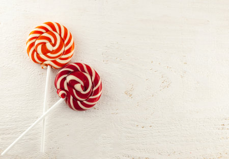 Red sweets lie on a white wooden table. Marmalade, marshmallow, ladies, fruit tea, sweetsの写真素材