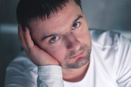 A young, attractive man in the morning in the kitchen is drinking coffee, smilingの写真素材