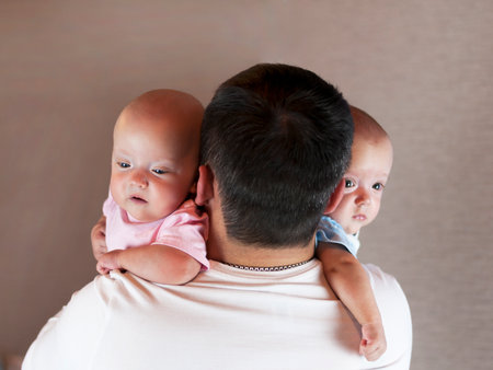Young father with his newborn twins. Selective focusの写真素材