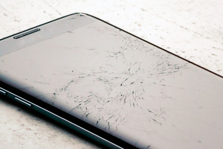 Broken touch screen of a black smartphone.
