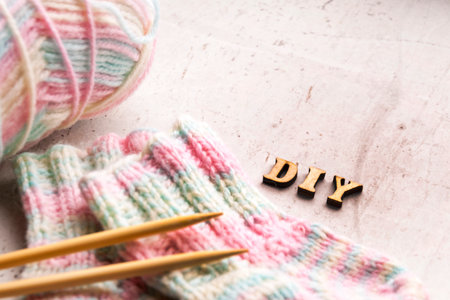 DIY Knitted pink warm wool socks for a newborn girl. Selective focusの写真素材