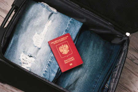 Travel concept. Jeans, card and Russian federation passport In the suitcase Selective focus.の写真素材