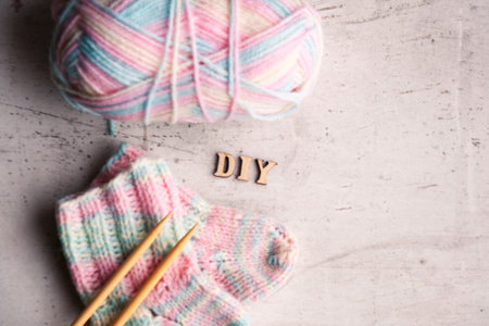 DIY Knitted pink warm wool socks for a newborn girl. Selective focus