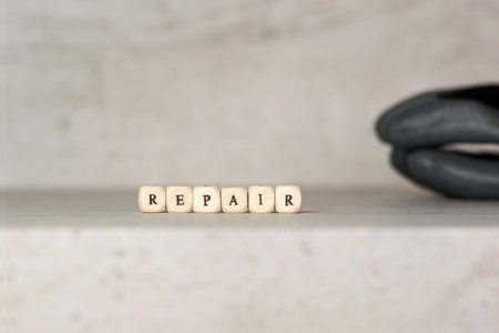 Gray with black work gloves on the background of the inscription repair in the foreground. Concept safety in the workplace. DIY.の写真素材