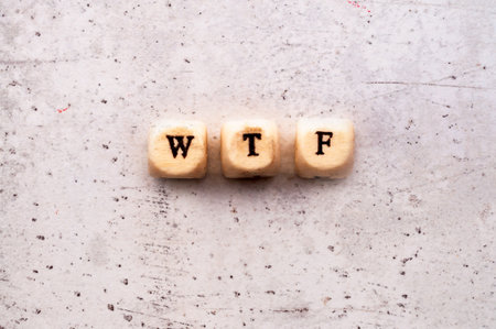 Inscription wtf COLORED abbreviation in wooden letters on a light backgroundの写真素材