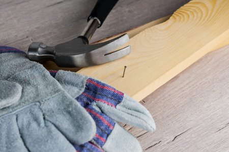Work on the construction or repair of the house.Use working gloves and a hammer. Concept for DIY,...