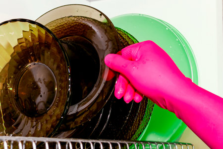 Dish dryer in the closet. White background. Plates of different colors. Cleaning, cleanlinessの写真素材
