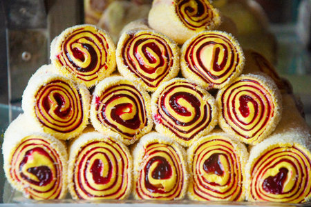 Oriental sweets on the counter of the store. Sweet rolls are folded with a pyramid. Organization of...