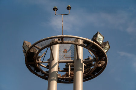 Tower of lighting and equipment at the airport against the blue sky. Engineering systems of the...