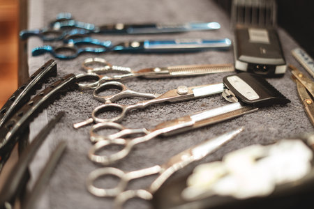 Barber tool in barbershop. Hairdresser tool. Scissors, combs, razors, clippers. Tool for the wizard. Organization of the workplace. Selective focusの写真素材