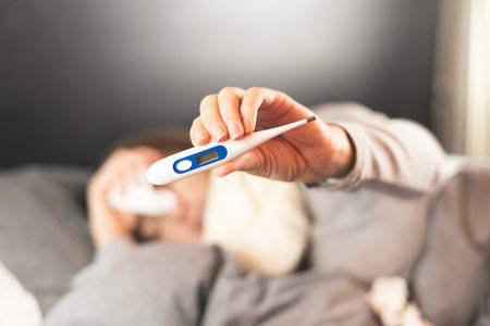 Disease. Home treatment. Flu and the common cold. A woman is sick at home, runny nose and flu. Body...