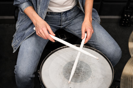 Creativity and music. Young beautiful girl plays the drums. Recording Studio. Musical equipment.の写真素材