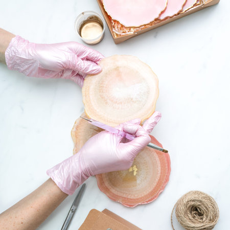 Creativity and craft. A young girl creates coasters from resin. Gift wrapping. Decorative packaging. Idea for business. Remote work, work at home. Art coastersの写真素材