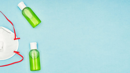 Coronavirus, covid-19. Antiseptic gel, liquid we, protective mask on a blue background....