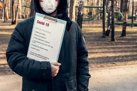 A man in a protective mask in an empty park. How to protect yourself from coronavirus. Quarantine...