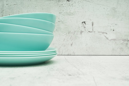 A stack of dishes on a light background. Glass set of dishes for the kitchen. close up