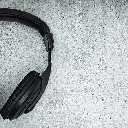 Large, black headphones lie on a colored background. Device for individual listening to musicの写真素材