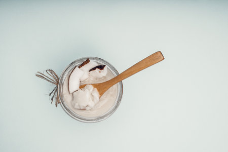 Parts of coconut on a colored background. Close up. Fresh ripe coconut broken into pieces. Coconut oil.の写真素材