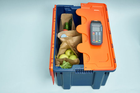 Plastic box with products. Food delivery in platinum boxes. Safe delivery. Storage of fragile goods.