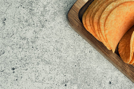 Potato chips on a wooden stand with sauces. Ready meal from the menu. Unhealthy food and beer snack.の写真素材