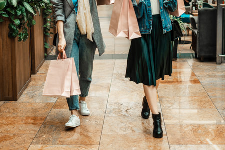 Trade, buyers. Two beautiful girls make purchases in a shopping center, go shopping. The joy of consumption.の写真素材
