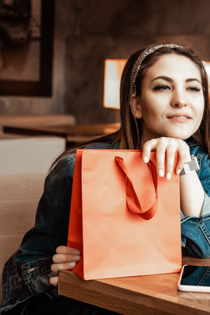 Trade, buyers. Two beautiful girls make purchases in a shopping center, go shopping. The joy of consumption.の写真素材
