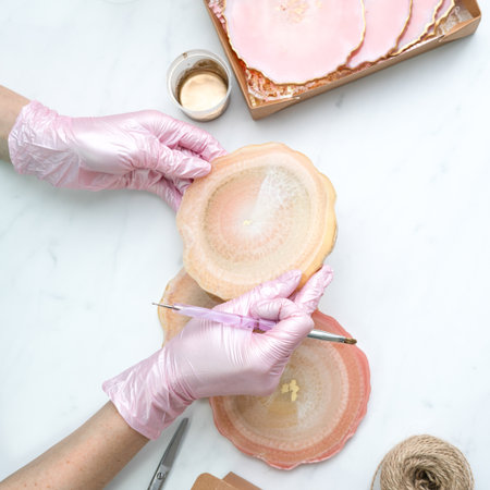 Creativity and craft. A young girl creates coasters from resin. Gift wrapping. Decorative packaging. Idea for business. Remote work, work at home. Art coasters.の写真素材