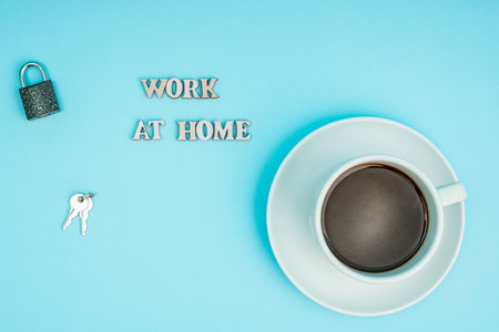 Coronavirus, covid-19. The inscription stay home on a blue background, a cup of coffee. Self-isolation and quarantine, personal protective equipmentの写真素材