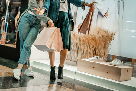 Trade, buyers. Two beautiful girls make purchases in a shopping center, go shopping. The joy of consumption.の写真素材