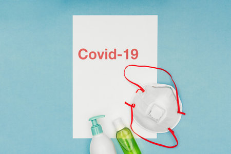 Coronavirus, covid-19. The inscription covid-19 on a blue background. Self-isolation and quarantine, personal protective equipment, ampoule and syringe.の写真素材