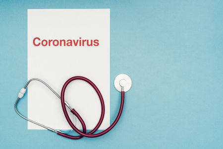 Coronavirus, covid-19. The inscription coronavirus on a blue background. Self-isolation and quarantine, personal protective equipment, phonendoscope and stethoscope.の写真素材