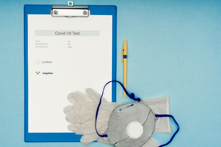 Coronavirus, covid-19. Coronavirus test results on a blank, blue background. Protective mask and gloves. Self-isolation and quarantine, personal protective equipment.の写真素材
