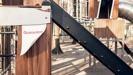 Quarantine advertisement on an empty playground in the park. Self-isolation and quarantine in a pandemic.の写真素材