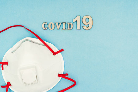 Coronavirus, covid-19. The inscription covid-19 on a blue background. Self-isolation and quarantine, personal protective equipment, ampoule and syringe.の写真素材