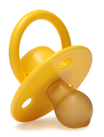 yellow  baby\'s dummy isolated on a white の写真素材