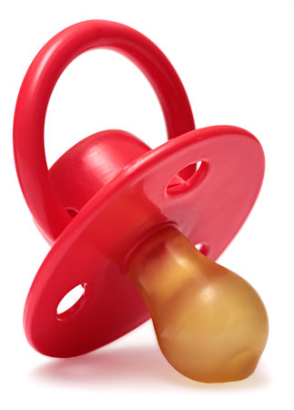 baby's dummy red isolated on a white background.の写真素材