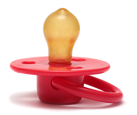 baby\'s dummy red isolated on a white .の写真素材