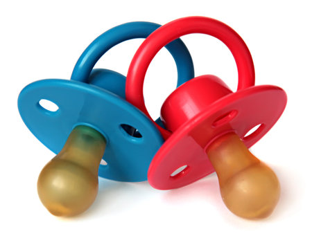 two baby\'s dummy red and blue isolated on white .の写真素材