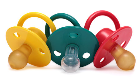 Three baby\'s dummy red, yellow and green isolated on white .の写真素材