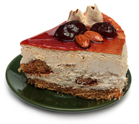 piece of cake with nuts and prunes on a white .の写真素材