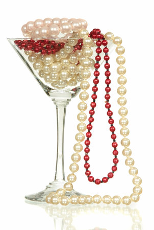 Beads from pearls in wine glass for martini isolated on a white の写真素材