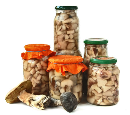 Marinaded mushrooms. Jars of pickles with forest mushrooms.の写真素材