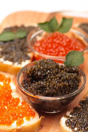 Black and red caviar in a glass containerの写真素材